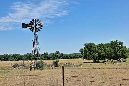 A windmill with its sucker rod pulled off Purgatory Road in rural Texas