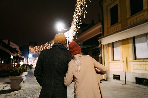 Photo of a young couple having romantic Christmas walk