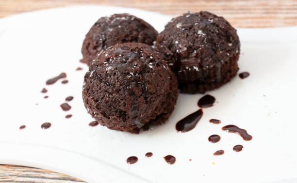 istock Chocolate muffins with coconut flakes. 1339040441