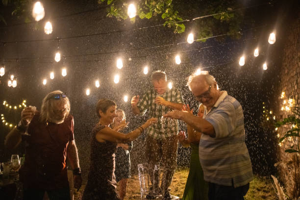 istock Happy senior friends having a best time in life on party at backyard while it's raining 1339041742
