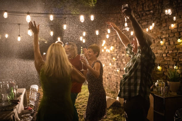 istock Senior people dancing and enjoying party despite the rain 1339041959