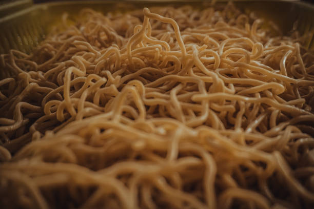 istock Close-up of yellow noodles in a plastic basket 1339042017