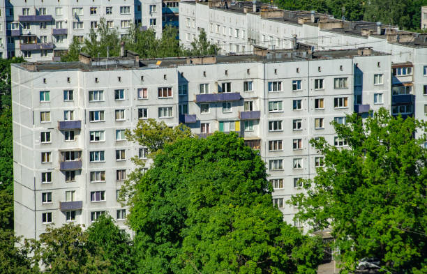 VIew from above of multi-storey panel building in residential area of Riga. Green trees. Citiscape. Top view.