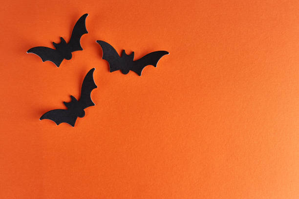 istock Halloween bats decorations on orange background 1339044727