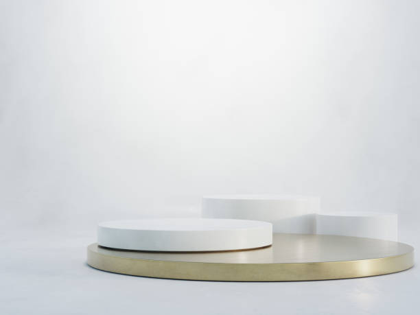 istock Round white marble podium with a metallic gold base on concrete floor and empty wall background in luxury studio scene. 1339045813