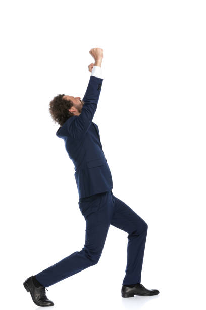 istock handsome businessman walking while celebrating success 1339046081