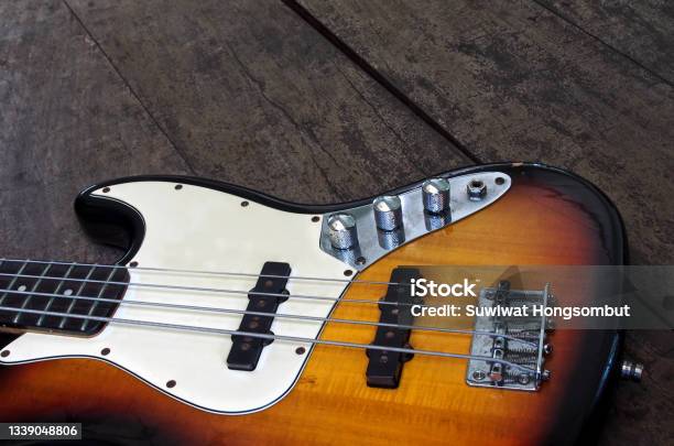 Bass Guitar On The Floor Stock Photo - Download Image Now - Bass Guitar, Guitar, Electric Guitar