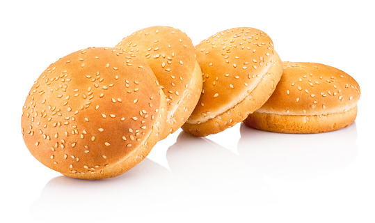 Four hamburger buns with sesame isolated on a white background