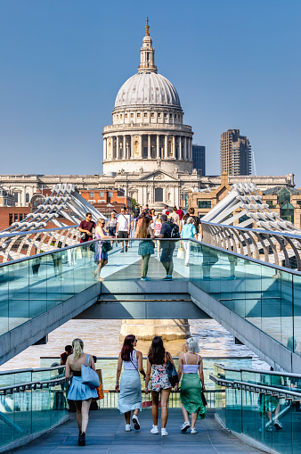 London, UK - Sep 7, 2021: People walking at St Paul's Cathedral across the Millennium Bridge over the River Thames