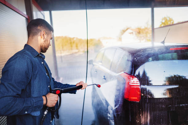 istock Man washes the car with a hose before going on the road 1339051516