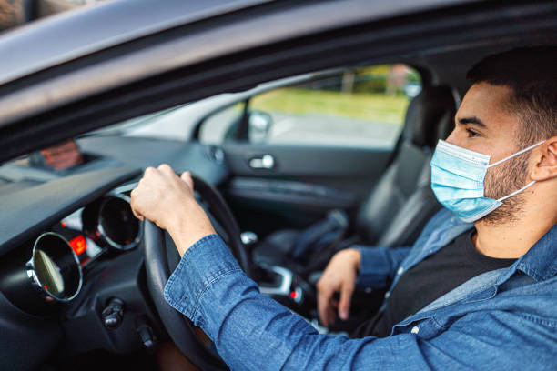 istock Man with protective mask adriving a car by Coronavirus pandemic quarantine 1339051621