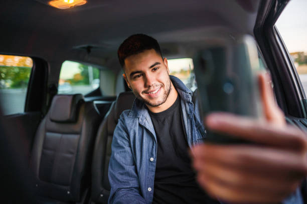 istock Happy man taking selfie on mobile phone in car 1339051649