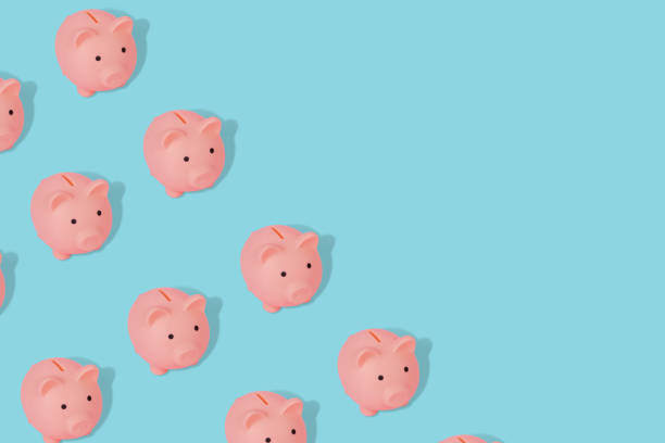 istock Cute and modern pattern with a piggy banks on a blue background. Copy space 1339053918