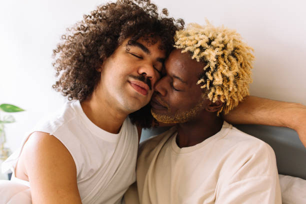 istock Romantic young gay couple bonding at home 1339054174