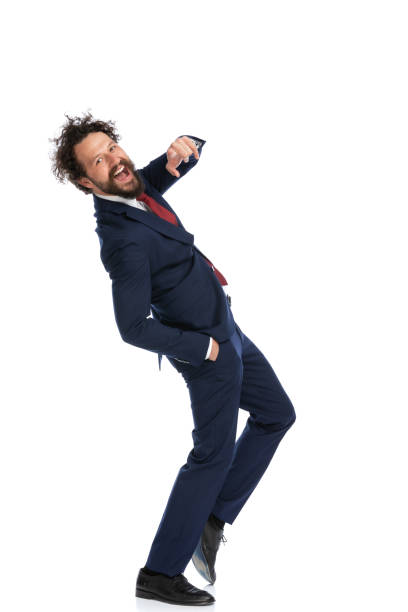 istock businessman pointing at the camera, sticking one hand in pocket 1339056882