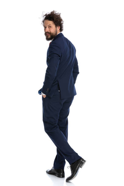 istock cool businessman walking with his hands in pockets 1339057785