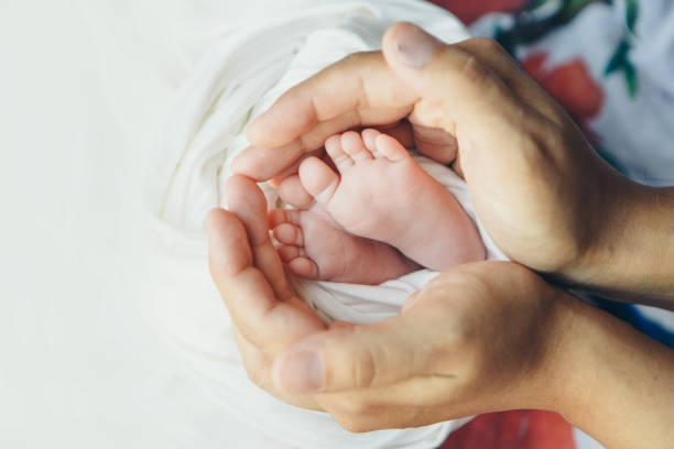 istock baby feet close up on white background 1339057873