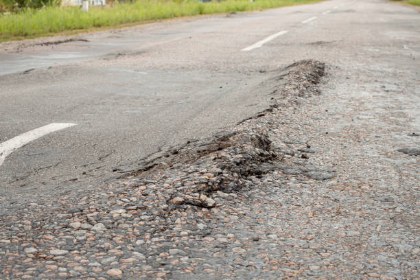 istock Destroyed asphalt surface because of heavy trucks driving 1339058037