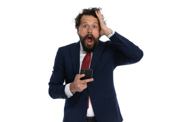 istock handsome businessman slapping his head and holding a telephone 1339058122