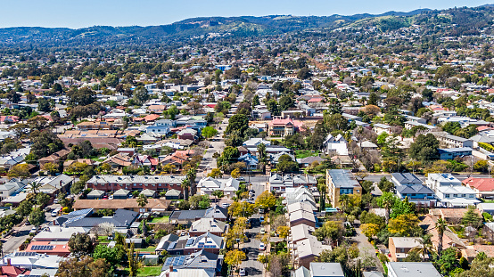 Aerial view of sprawling leafy eastern suburbs of Adelaide with Mt Lofty Ranges in the background