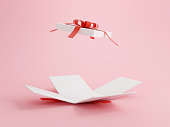 istock Open gift box with red ribbon over pink background. Happy birthday, Merry Christmas, New Year, Wedding or Valentine Day concept. 3D rendering illustrations. 1339064042