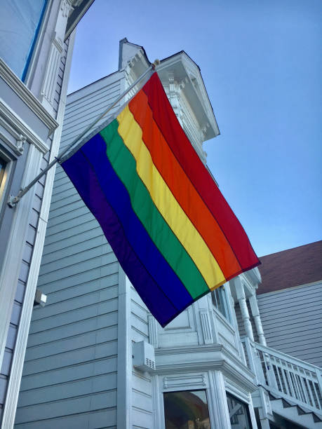 istock rainbow pride flag unfurled hanging from a building 1339065241