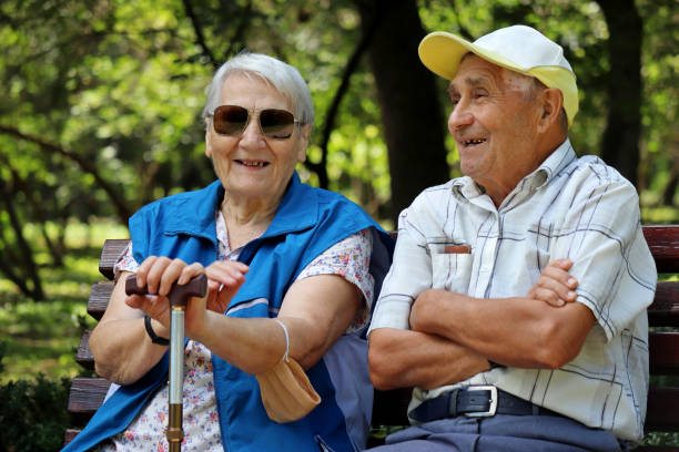 Happy elderly couple sitting on a bench