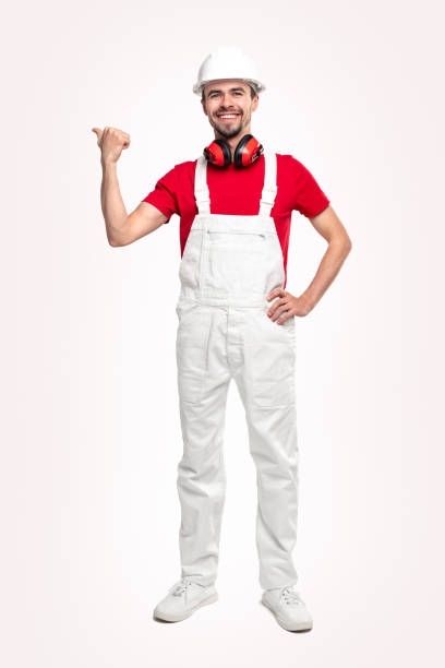 istock Friendly repairman in workwear pointing away 1339066631