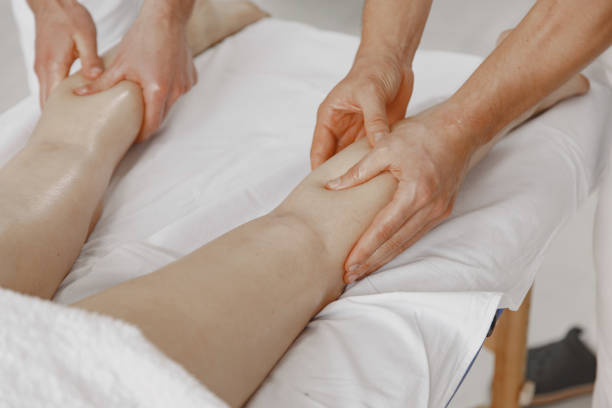 istock Four hands do massage to female body 1339068144