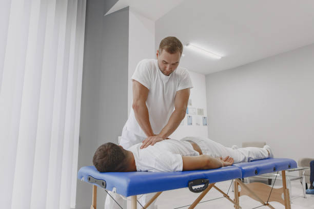 istock Male physiotherapist massaging man's back 1339068369