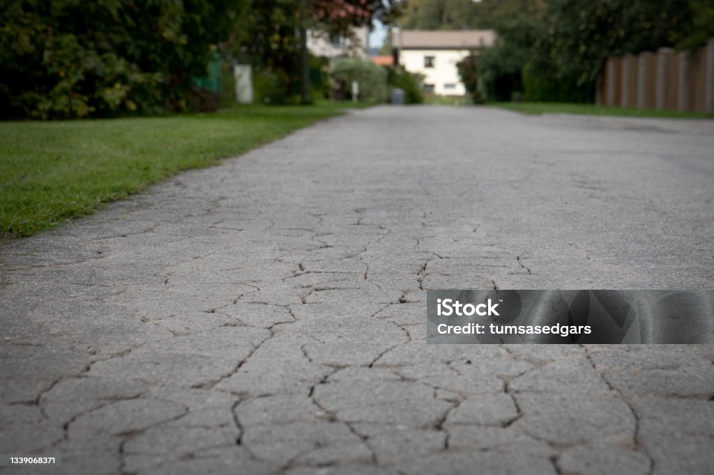 City street view with old cracked asphalt pavement City street view with old cracked asphalt pavement. Abstract Stock Photo
