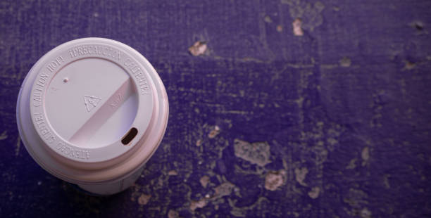istock close up of a cup of coffe on violet texture background. space for text 1339069208