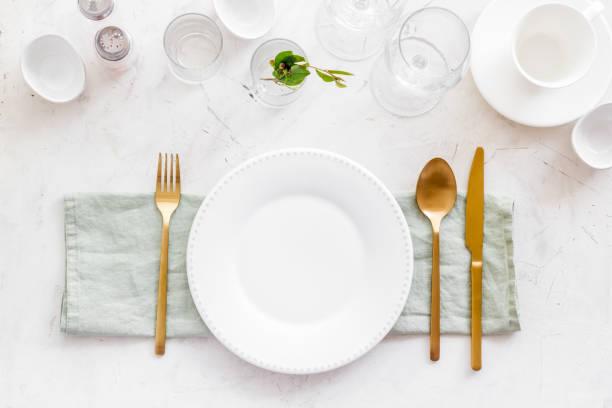 istock Eating utensil set - table setting for dinner with plate on napkin 1339072049