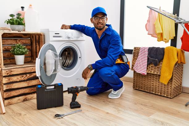 istock Young indian technician working on washing machine winking looking at the camera with sexy expression, cheerful and happy face. 1339077951
