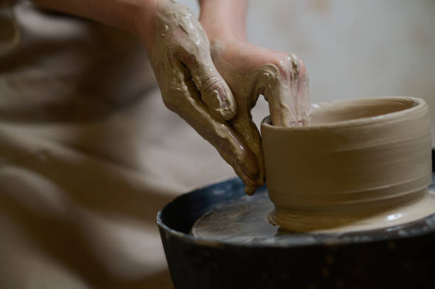 istock Close up of human hands making a bowl on a pottery wheel 1339078422