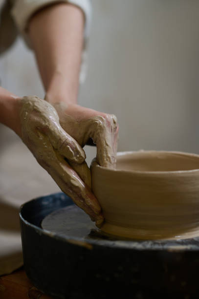istock Close up of human hands making a bowl on a pottery wheel 1339078433