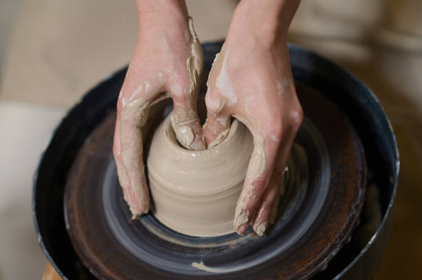 istock Close up of human hands on a pottery wheel 1339078565