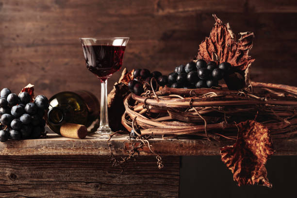 red wine with grapes on an old wooden table. - vinho do porto imagens e fotografias de stock