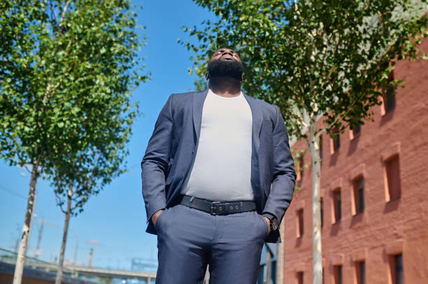 istock A dark-skinned man in a suit standing in the street 1339085132
