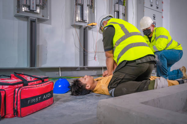istock Electric worker suffered an electric shock accident unconscious. Safety team CPR for first aid Electric worker loses in electric shock accident at work on site. Accident in control room of factory. 1339085251
