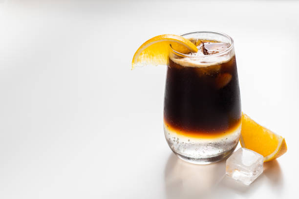 coffee tonic with orange There is a glass of coffee tonic with ice and orange juice tonic water stock pictures, royalty-free photos & images