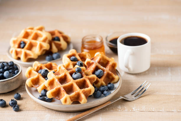 istock Belgian waffles with blueberries and coffee 1339085431