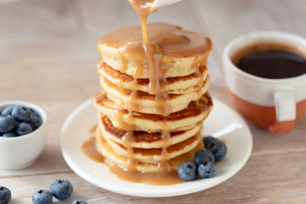 istock Caramel sauce pouring over pancakes 1339086091