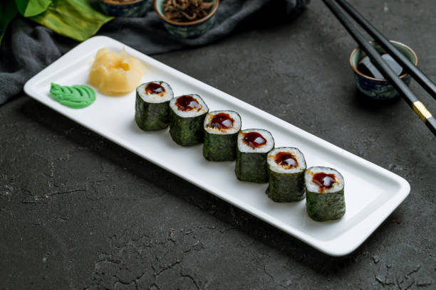 istock Roll unagi Maki on white plate on dark stone table 1339086580