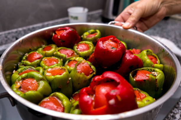 Stuffed peppers to cook on the stove in a pot Close-up of a pot of stuffed peppers about to cook stuffed pepper stock pictures, royalty-free photos & images