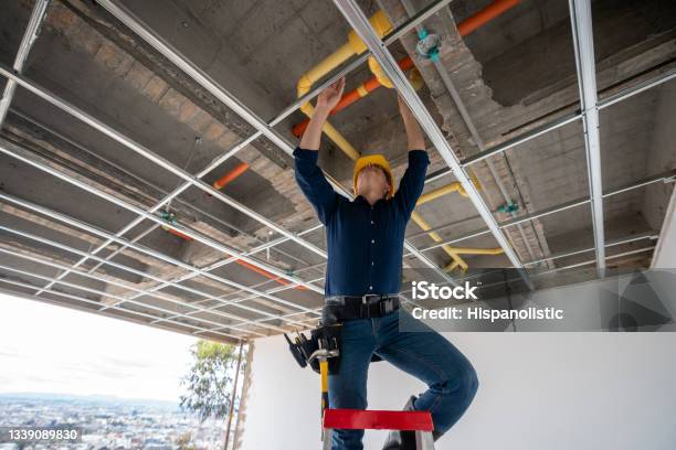 Building Contractor Checking The Pipes At A Construction Site Stock Photo - Download Image Now