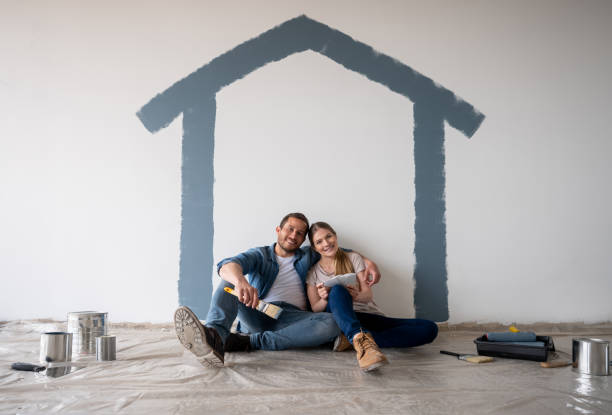istock Happy couple taking a break while painting their house 1339089837