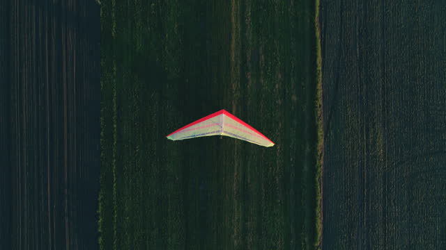 Hang glider preparing for takeoff on the grass runway