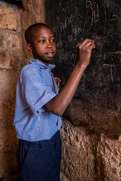 istock African young boy is learning English language, orphanage in Kenya 1339094565
