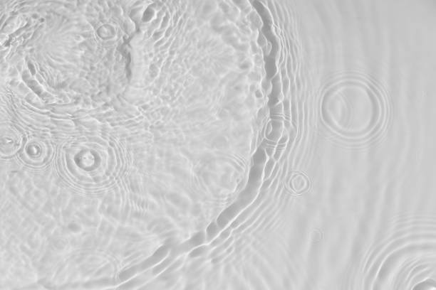 istock Water tranquil ripple background. Water texture, circles and bubbles on a liquid white surface. Cosmetic products and flat design concept 1339095923
